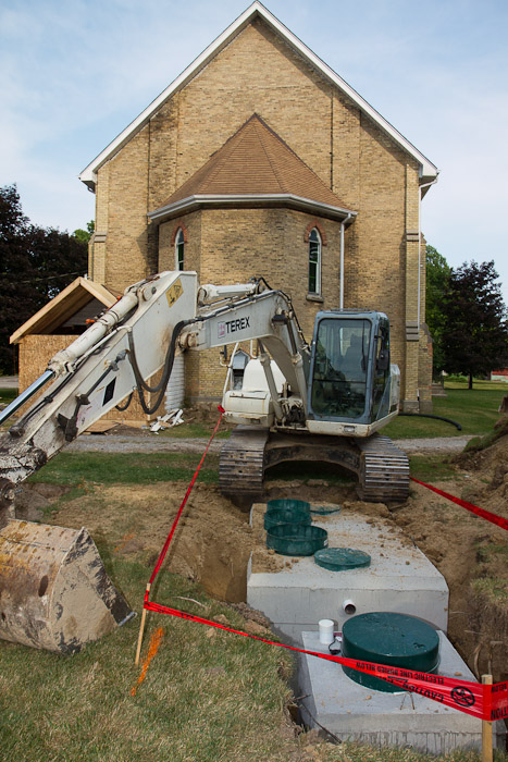 The septic tank with the pump and excavator.